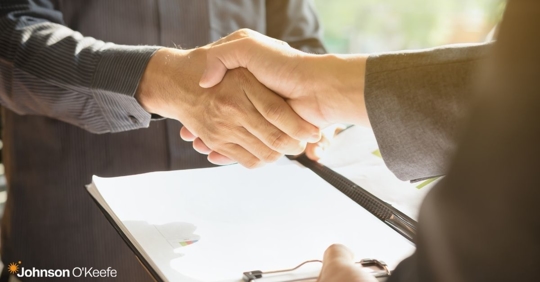 two individuals shaking hands