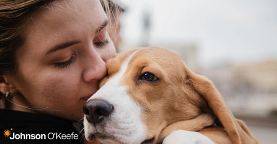 a woman showing her dog affection